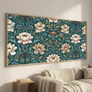 May include: A rectangular wall art piece featuring a repeating floral pattern on a dark teal background. The design includes large cream-colored blossoms, smaller blue flowers, and orange thistle-like accents, all framed in a light wood border.