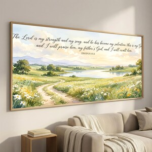 May include: A framed watercolor print featuring a serene landscape with a winding path, a lake, and rolling hills under a cloudy sky. The artwork includes the text "The Lord is my strength and my song... Exodus 15:2" in elegant script.