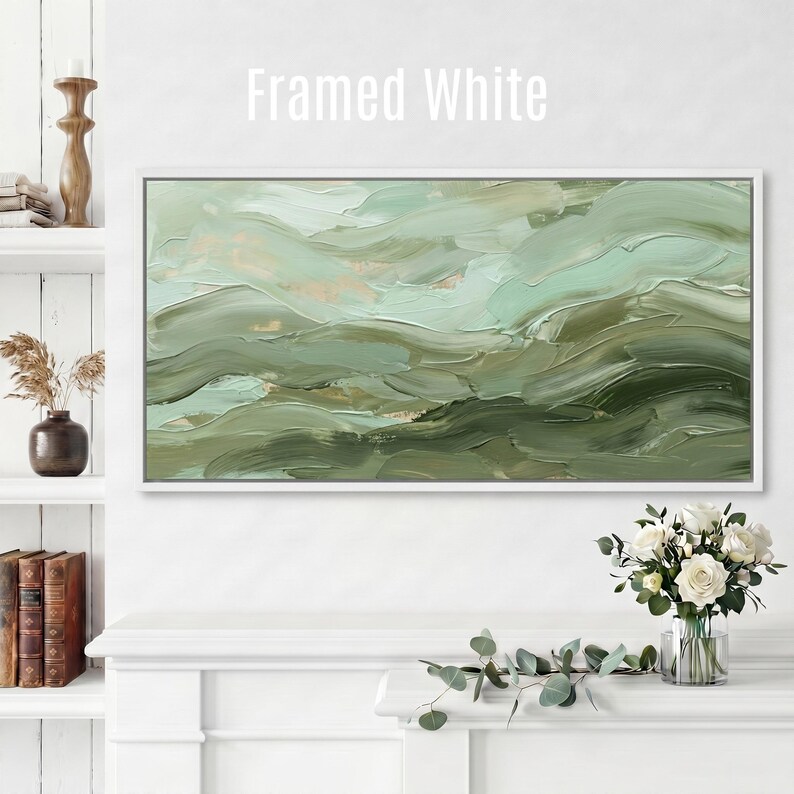 May include: A framed white abstract painting with a textured, layered appearance. The artwork features shades of green and beige, creating a sense of depth and movement. The text "Framed White" is displayed at the top.