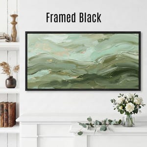 May include: A framed abstract painting with a black border. The artwork features a textured, layered design in shades of green and beige, with the words "Framed Black" at the top.