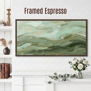 May include: A framed abstract painting with a dark brown frame. The artwork features layered brushstrokes in shades of green and beige, creating a textured, wave-like effect. The text "Framed Espresso" is displayed above the painting.