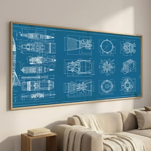 May include: A large rectangular wall art piece featuring white technical blueprint line drawings of various rocket components and engine parts set against a solid blue background, all enclosed within a thin light-colored wooden frame.