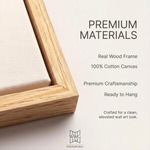May include: Close-up of a canvas print with a light wood frame. The text "PREMIUM MATERIALS" is visible, along with details about the real wood frame and 100% cotton canvas. The print is ready to hang.