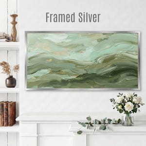 May include: A framed abstract painting with a silver frame. The artwork features layered brushstrokes in shades of green, creating a textured, wave-like effect. The text "Framed Silver" is at the top of the image.