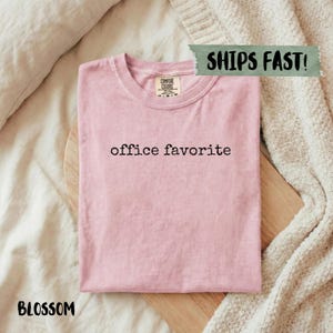 Blossom pink t-shirt with "office favorite" text, Ships Fast! tag.