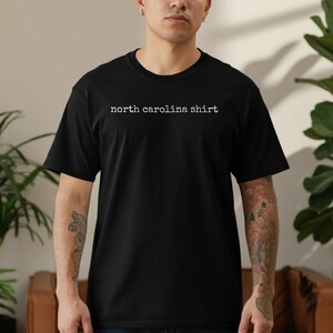 Black t-shirt with "north carolina shirt" printed in white text.