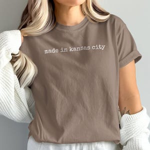 Brown t-shirt with "made in kansas city" printed in white text.