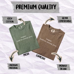 Two t-shirts, one moss green and one espresso brown, with "vegan just to annoy you" printed on them.