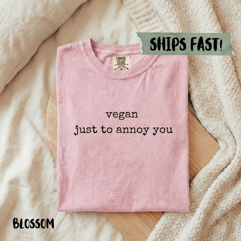 Pink t-shirt with "vegan just to annoy you" text.