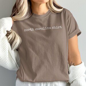 Brown t-shirt with "north carolina shirt" printed in white text.