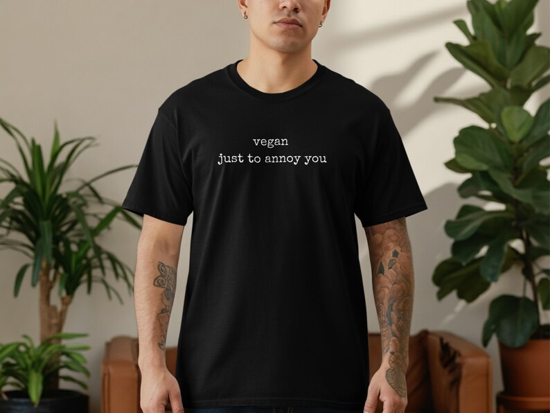 Black t-shirt with "vegan just to annoy you" text.