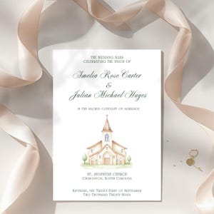 Puede incluir: Una invitación de boda con los nombres Amelia Rose Carter y Julian Michael Hayes. La invitación incluye el texto "The Wedding Mass Celebrating the Union of" y "In the Sacred Covenant of Marriage." Una ilustración en acuarela de la iglesia de San Agustín está en la parte inferior.