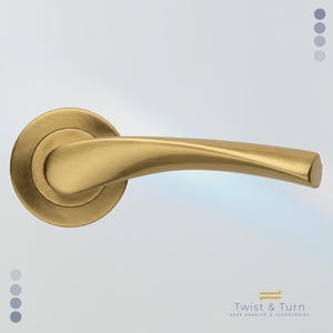 May include: A gold-toned door handle with a curved lever and a circular base. The handle has a smooth, metallic finish and is designed for easy gripping. The text "Twist & Turn DOOR HANDLES & ACCESSORIES" is visible in the bottom right corner.