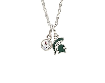 May include: A silver necklace with a green and silver Spartan helmet charm and a clear crystal charm.