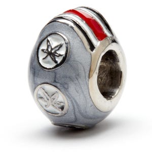 May include: A silver charm bead with a gray and white marbled design. The bead has two white and silver seahorse charms and a red, white, and black striped band.
