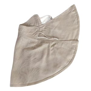 May include: A beige sun visor with a wide brim and a drawstring closure. The visor is made of a textured fabric and has a curved shape to provide shade. The design includes a strap to secure it to the head.