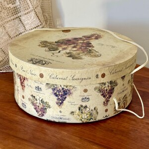 13in Hat Box w Rope Handle 13" x 5 1/2” Lauren Hamilton 2003 Tri-Coastal Designs Inc By Art in Motion Grape Artwork, French Wine Labels