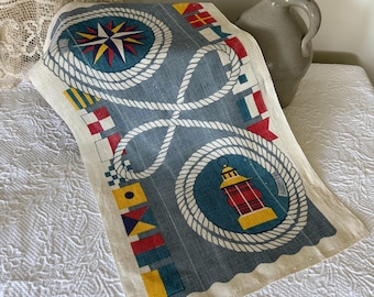Paño de cocina decorativo de lino con motivos náuticos.