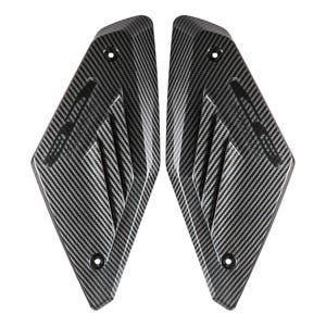 May include: Two carbon fiber motorcycle fairing panels. Each panel has a textured, woven pattern in shades of gray and black. The panels are shaped with angled edges and include mounting holes for secure attachment to a motorcycle.