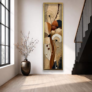 Puede incluir: Una pieza de arte mural rectangular vertical y alta, enmarcada en oro, que presenta una composición abstracta texturizada de esferas tipo diente de león, elementos en forma de abanico y curvas orgánicas en tonos crema, beige, marrón, óxido, azul marino y pan de oro.