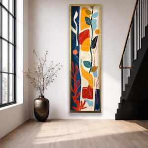 Puede incluir: Una pieza de arte mural alta y rectangular en un marco dorado que presenta una composición abstracta de formas orgánicas y líneas en azul marino, rojo brillante, amarillo mostaza y azul claro, con un motivo de vid vertical en el centro.