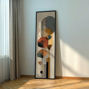 May include: Abstract art print in a black frame. The artwork features a beige background with geometric shapes in shades of orange, blue, and yellow. Stylized plant-like forms are also present, adding a natural element to the design. The artwork is displayed vertically.