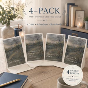 May include: A 4-pack of faith-inspired greeting cards featuring four unique designs with watercolor-style landscapes of trees under a dark sky. Each card includes a different inspirational quote and blank interior, accompanied by four envelopes.