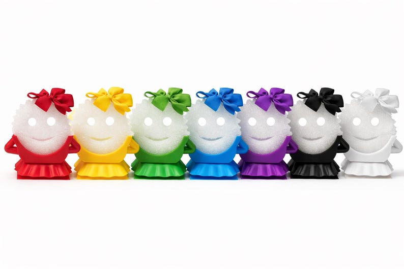 May include: A row of seven smiling, white, spherical figures with glowing eyes. Each figure wears a different colored outfit: red, yellow, green, blue, purple, black, and white. Each has a matching bow on top.