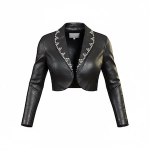 May include: A black leather bolero jacket with long sleeves. The jacket features a decorative pattern of small, silver-colored embellishments along the collar and lapel edges. The jacket has a cropped design, ending just below the bust.