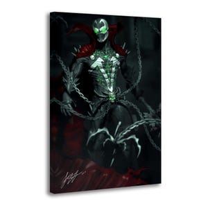 May include: A canvas print featuring a dark, armored character with a white mask, glowing green eyes, and a flowing red cape. The figure is adorned with silver skull accents and is surrounded by metallic chains against a dark, shadowy background.