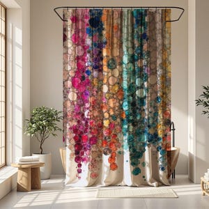 May include: A colorful shower curtain with a vibrant abstract design. The curtain features a cascade of overlapping circles in shades of pink, purple, blue, orange, and green against a neutral background. The curtain hangs in a bright bathroom setting.