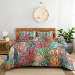 May include: A bedding set featuring a vibrant underwater coral reef print with clownfish, angelfish, and starfish. The design includes various coral structures in shades of orange, pink, and green against a teal blue background.