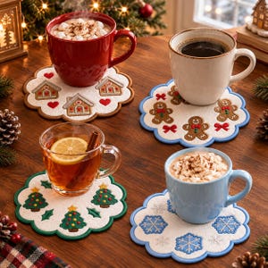 May include: Four round, scalloped-edge felt coasters featuring embroidered holiday designs: gingerbread houses with red hearts, gingerbread people with red bows, Christmas trees with stars, and blue snowflakes. Each coaster holds a mug of beverage.