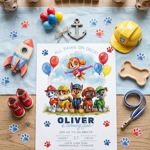 May include: A rectangular birthday invitation card featuring cartoon puppies, balloons, and the text ALL PAWS ON DECK, OLIVER is turning four, AUGUST 27, 3:30 PM, 23476 CLARE ROAD, HENDERSONVILLE, TENNESSEE, and RSVP TO KENZI AT 555-555-5555.