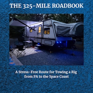 May include: A travel trailer with an awning is parked outdoors at night. The text "THE 325-MILE ROADBOOK" is at the top, and "A Stress-Free Route for Towing a Rig from PA to the Space Coast" is at the bottom.