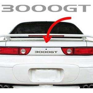Adesivo com o emblema central traseiro do Mitsubishi 3000GT (3KGT AWD TT VR-4)