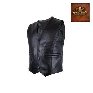 May include: A black leather waistcoat featuring a V-neckline, four front snap buttons, and two horizontal slit pockets. The garment has a smooth finish with visible seam detailing along the front panels and a dark interior lining visible at the collar.