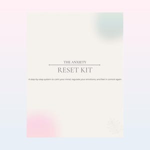 May include: A cream-colored card with the text "THE ANXIETY RESET KIT" in a serif font. Below the title is the text: "A step-by-step system to calm your mind, regulate your emotions, and feel in control again."