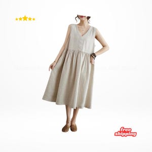 May include: A beige sleeveless midi dress with a V-neckline and button details. The dress has a gathered waist and a flowing skirt. The model is wearing the dress with patterned shoes. The image also includes a "free shipping" graphic.
