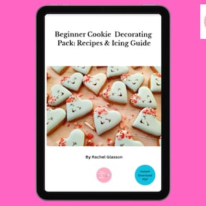 May include: A digital tablet displays a cookbook titled "Beginner Cookie Decorating Pack: Recipes & Icing Guide." The image features heart-shaped cookies with light blue icing and decorative sprinkles. The author's name and a "Instant Download PDF" button are also visible.