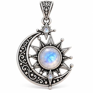 May include: A silver pendant featuring a crescent moon and a sun with a central round moonstone. The moon has intricate scrollwork and bead detailing. Two smaller moonstones are set in star-shaped accents at the top and bottom of the sun.