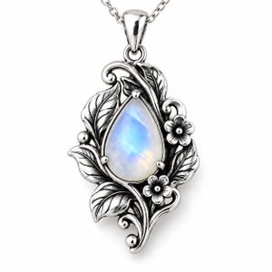 May include: A teardrop-shaped moonstone pendant set in oxidized silver. The setting features intricate metalwork depicting sculpted leaves and small flowers surrounding the central gemstone. The pendant hangs from a silver chain.