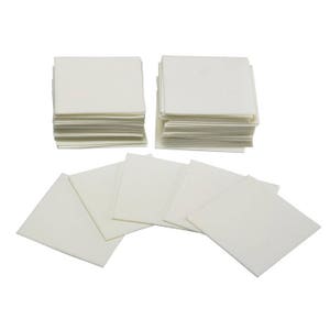 May include: A stack of white, square, paper cloths. There are two stacks of cloths, each with about 20 cloths. There are also five individual cloths laid out on a white background.