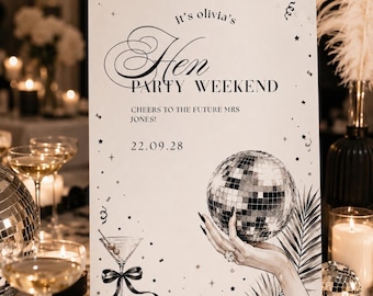 May include: A white rectangular sign featuring black text that reads It's olivia's Hen PARTY WEEKEND, CHEERS TO THE FUTURE MRS JONES!, and 22.09.28. The design includes a martini glass with a black ribbon and a hand holding a disco ball.