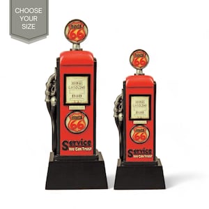 May include: Two red and black vintage gas pump shaped trophies with Route 66 signs and the words "Service You Can Trust".