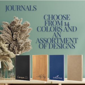 May include: Four different journals with personalized names and designs. The journals are black, wood, blue, and brown. The text on the journals reads "Carissa", "Abby Ray", "Longtail", and "JOURNALS CHOOSE FROM 14 COLORS AND AN ASSORTMENT OF DESIGNS".
