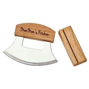 May include: A stainless steel curved knife with a wooden handle engraved with "Mom Mom's Kitchen". The knife comes with a wooden stand.