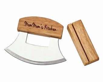 May include: A stainless steel curved knife with a wooden handle engraved with "Mom Mom's Kitchen". The knife comes with a wooden stand.