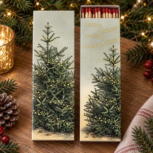 May include: A rectangular matchbox featuring a green Christmas tree illustration with gold lights. The text reads: a christmas tree, o christmas tree, how lovely are, how lovely are thy branches. The box is open, revealing red-tipped wooden matches.