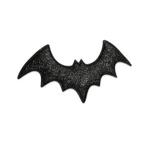 May include: A black bat-shaped patch featuring a glittery, sparkling texture across its entire surface. The design displays a classic bat silhouette with pointed ears, outstretched wings, and a scalloped lower edge, finished with a stitched border.